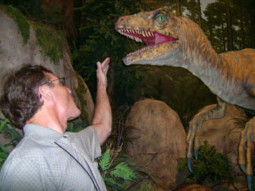 The author incautiously gestures toward a dinosaur in the Creation Museum.
