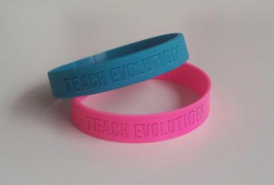 Wristbands reading "Teach Evolution"