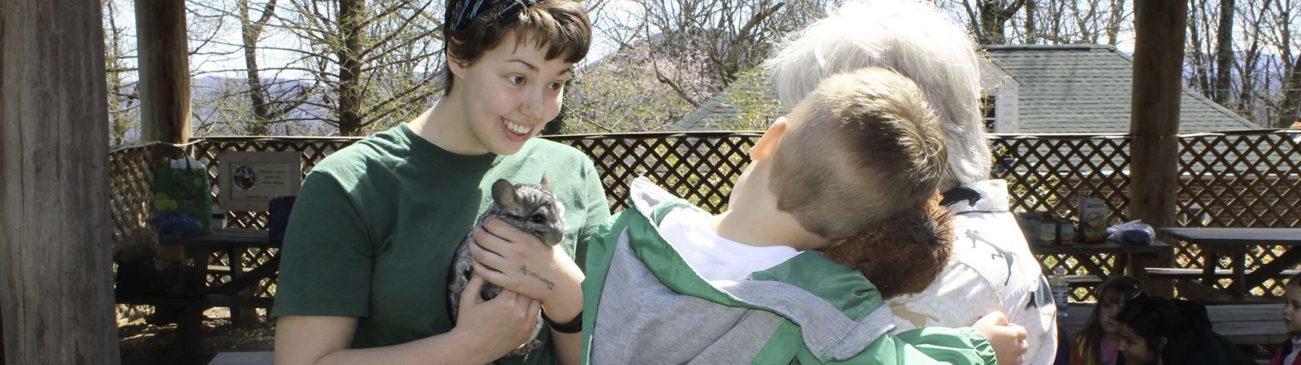 Visitors talk with a staff member at the Mill Mountain Zoo