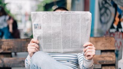 person reading a newspaper