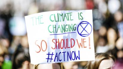 A sign saying "The climate is changing so act now"