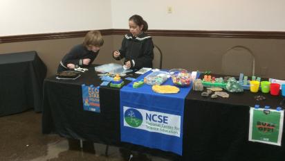 Youth setting up a science exhibit