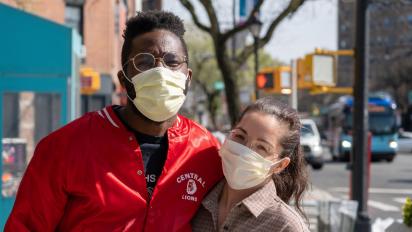two people wearing glasses and face masks