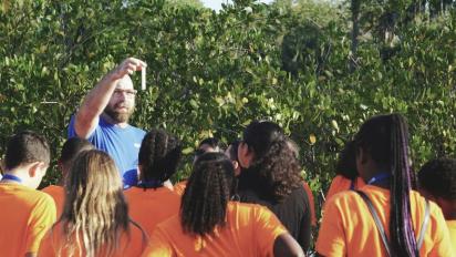 An instructor leading an outdoor science activity.