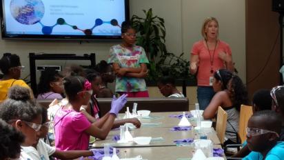 Science teacher in classroom with students.