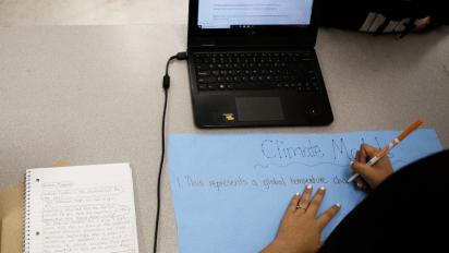 Student working on a climate model poster